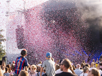 Open-Air-Bühne mit Konfetti und Publikum bei einer Live-Veranstaltung